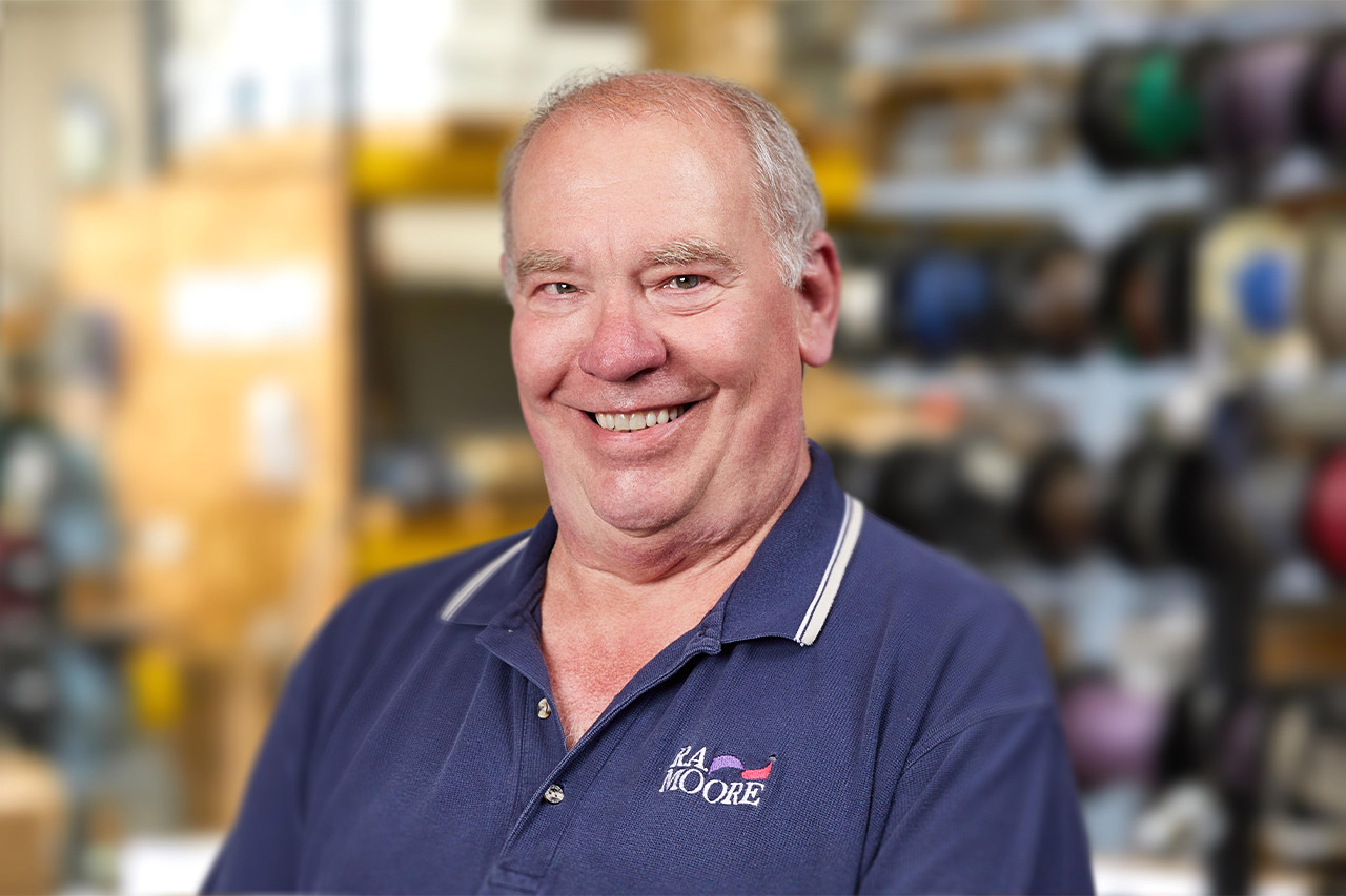 R.A. Moore Software Engineer Alan Anderson on an artistically out of focus warehouse interior background