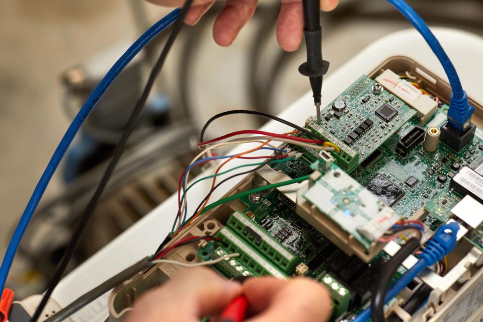 R.A. Moore employee working on an integrated circuit for equipment used in system integration