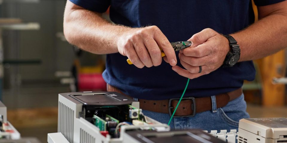 man clipping wire with wire cutters